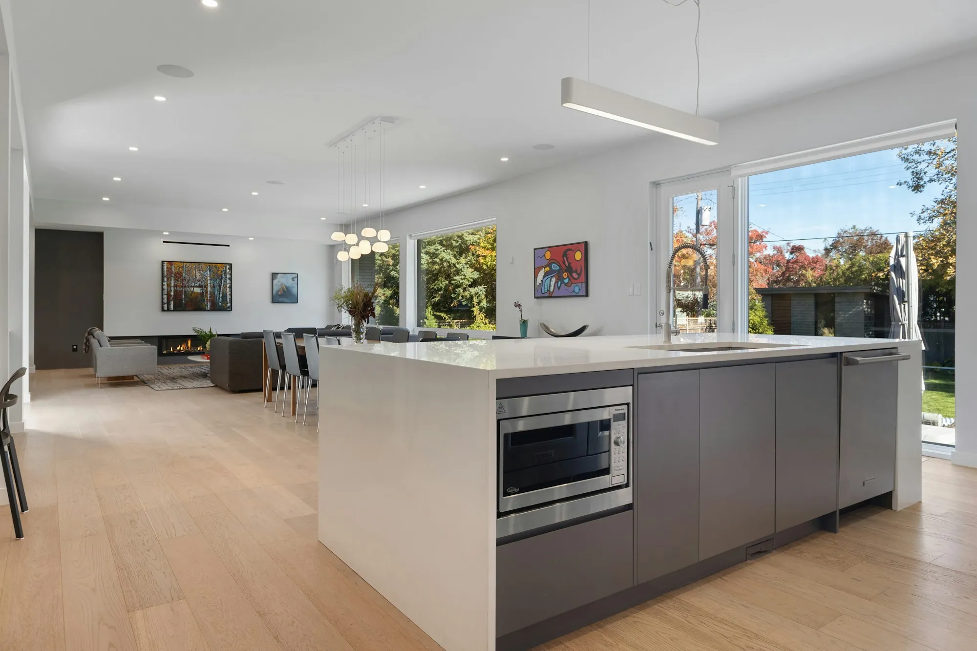 Open kitchen island with gray cabinets and a view of the yard